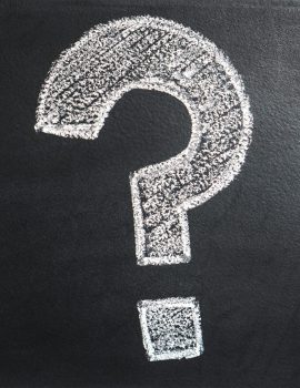 A conceptual image featuring a question mark drawn on a chalkboard, ideal for problem-solving contexts.